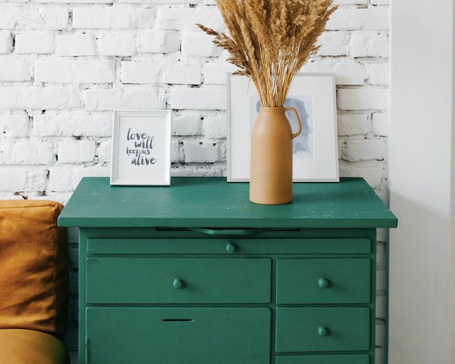 green drawer on white brick wall