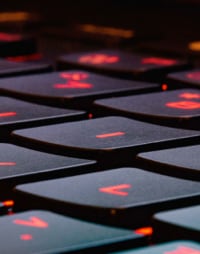 close up image of a black keyboard with red keys